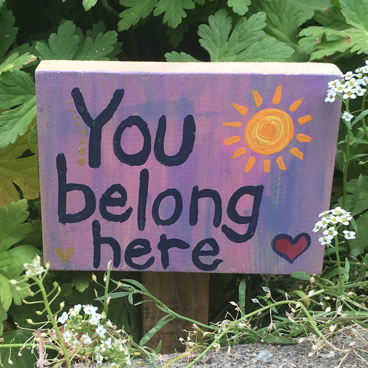 Sign reading "you belong here"