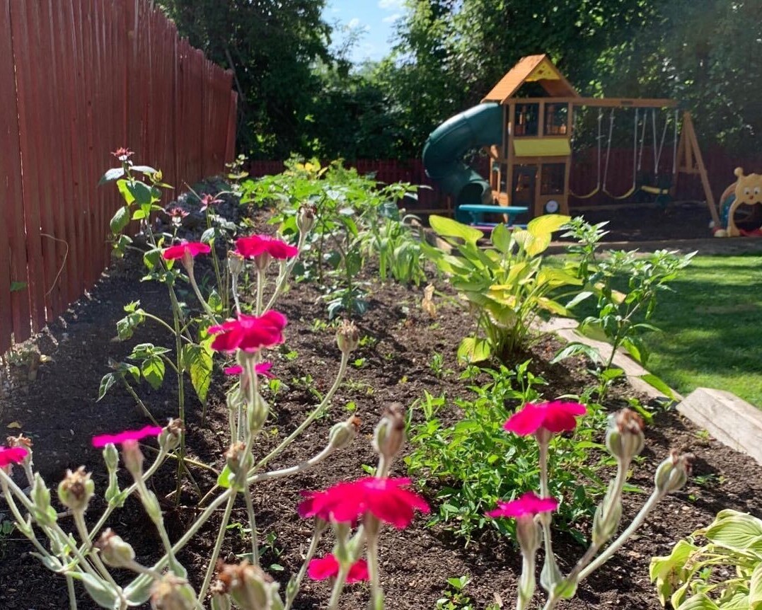 Garden with a children's play area in the background