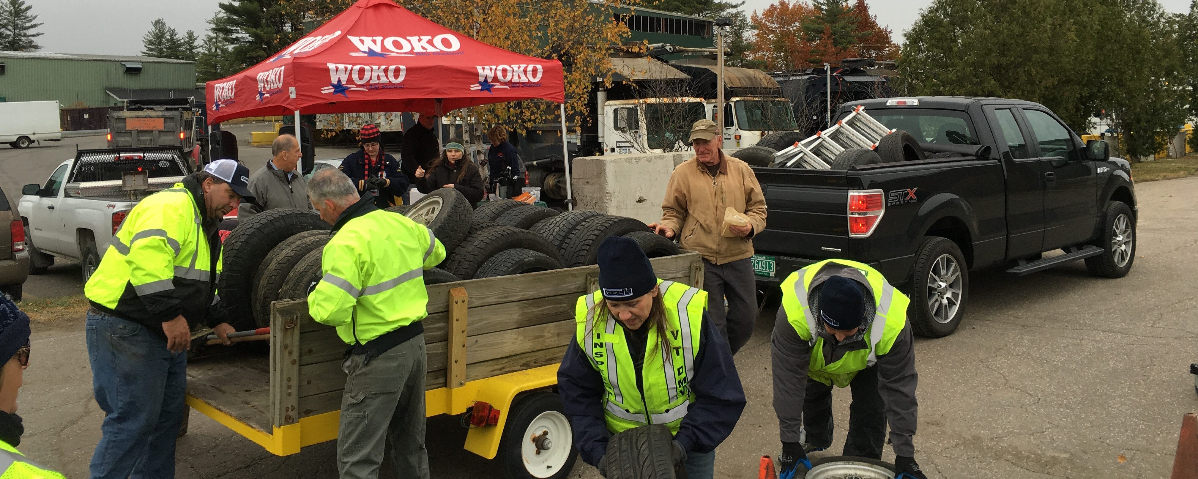 volunteers working around a trailer full of tires