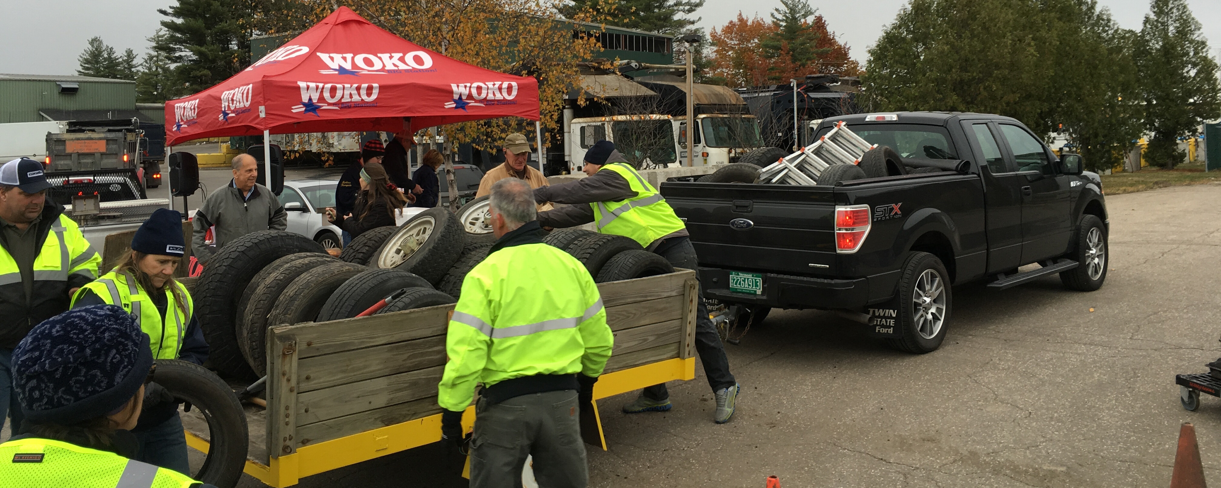 volunteers working around a trailer full of tires